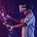 menino usando óculos de realidade virtual mexendo em um tablet gigante