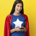 garota usando roupa de super herói enquanto usa seu smartphone fazendo alusão aos super apps