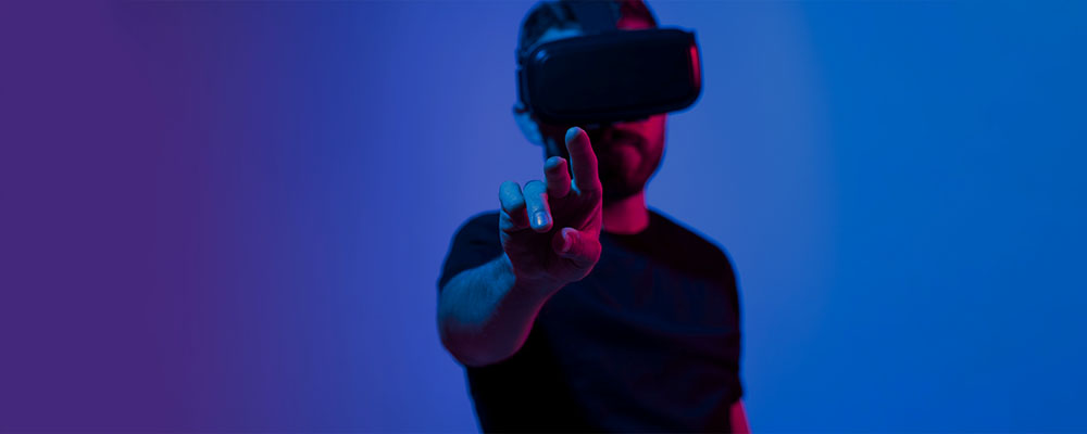 homem usando óculos de realidade virtual tocando em algo que pode ser visto no Metaverso